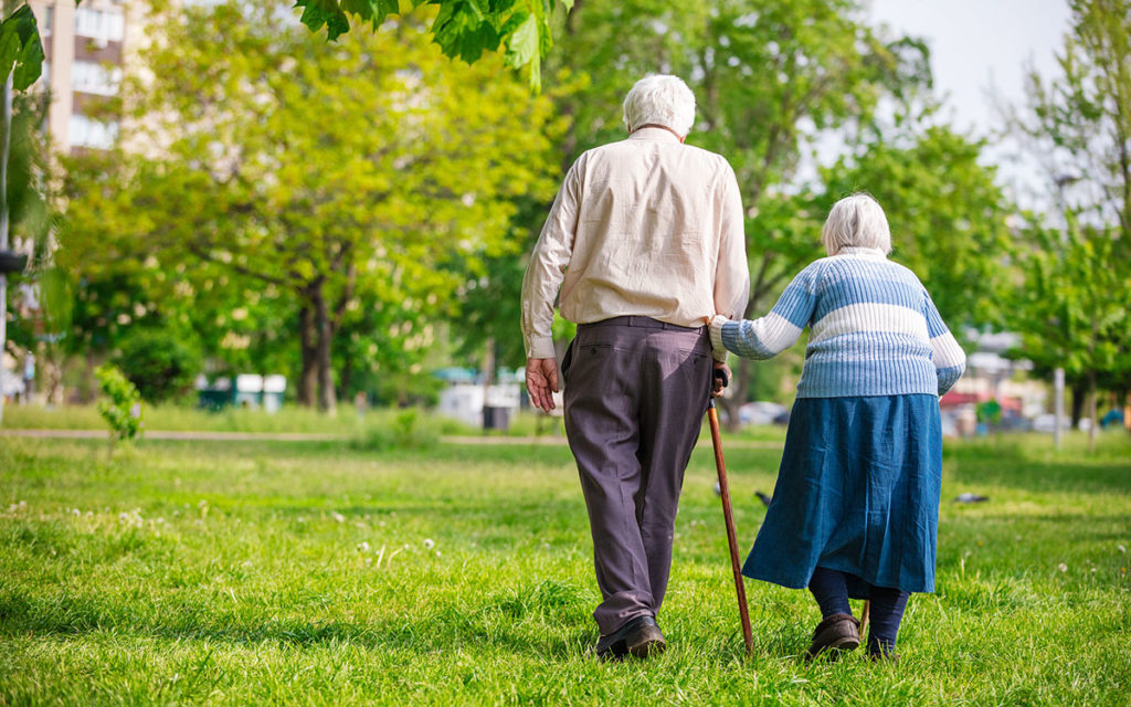 Senior couple walking outdoors in spring