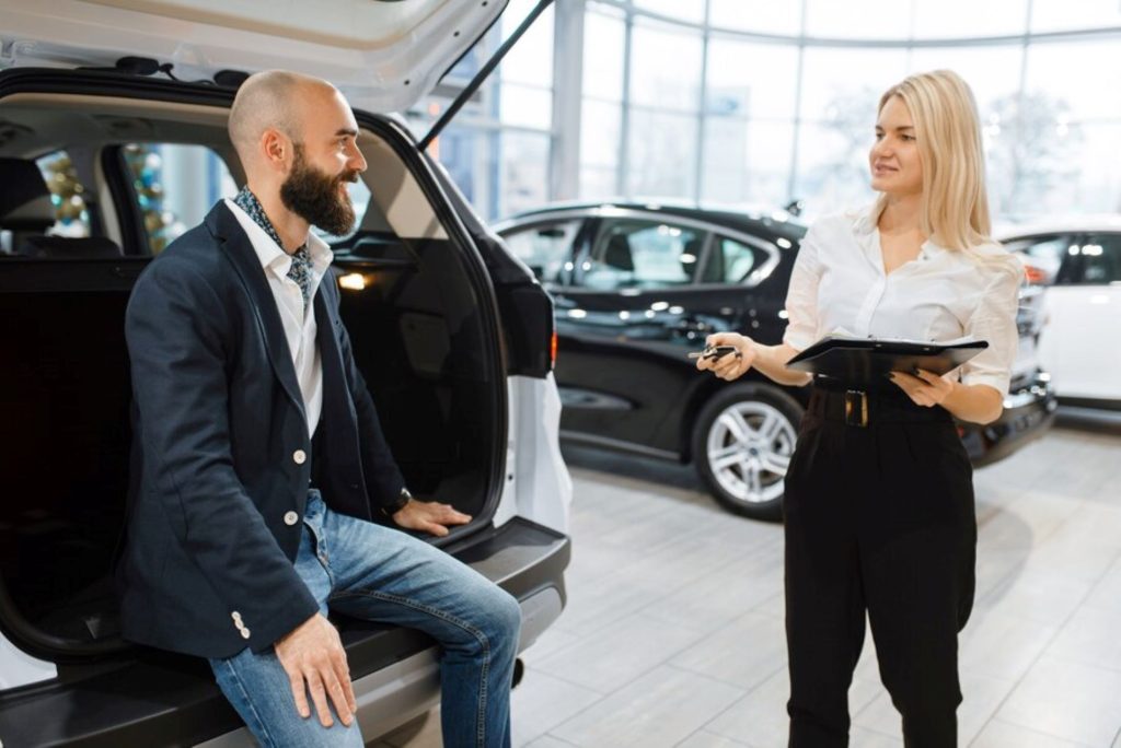 man-female-seller-choosing-auto-car-dealership-customer-saleswoman-vehicle-showroom-male-person-buying-transport-automobile-dealer-business_266732-21921